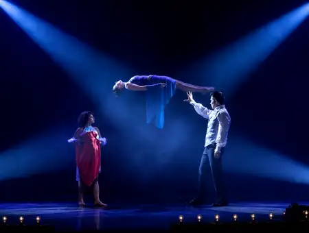 Magician levitating a woman on stage during a performance at Magic and Wonder Dinner Theater in Lancaster PA