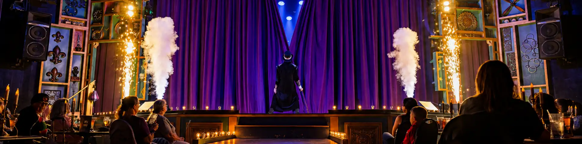 Magician on stage with fireworks and smoke effects at Magic and Wonder Dinner Theater in Lancaster PA