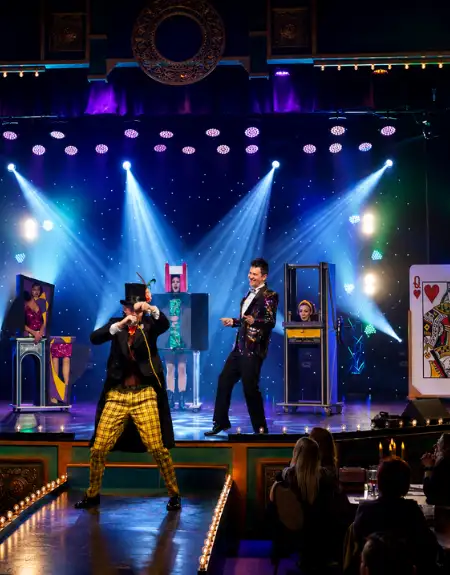 Magic and Wonder Dinner Theater magician singing on stage with sword box illusion in Paradise PA