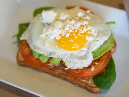 Avocado toast with fried egg feta and tomato at Main Street Cafe Lancaster PA