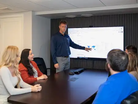 WebTek marketing team presenting digital marketing data on screen in Lancaster PA conference room