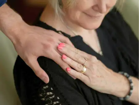 Landis at Home caregiver hand resting on shoulder of memory care patient in Lancaster PA