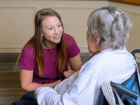 United Zion nursing care staff member talking with resident in wheelchair in Lancaster PA
