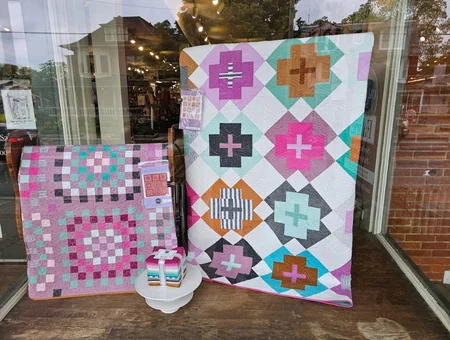 Handmade quilts displayed in The Old Country Store window, Intercourse PA quilt shop
