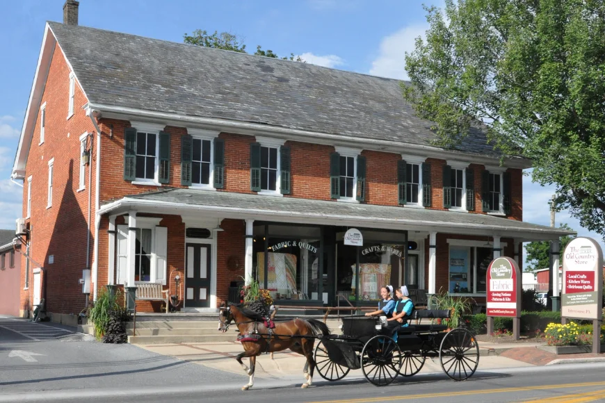The Old Country Store brick storefront with horse-drawn buggy passing by, Intercourse PA