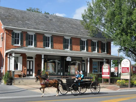 The Old Country Store brick storefront with horse-drawn buggy passing by, Intercourse PA
