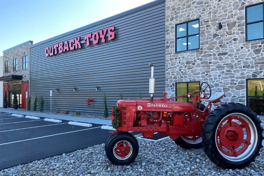Outback Toys storefront with vintage red Farmall tractor on display, Lancaster PA farm toy store