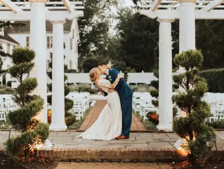 White Chimneys Estate bride and groom kissing under outdoor pergola in Lancaster PA