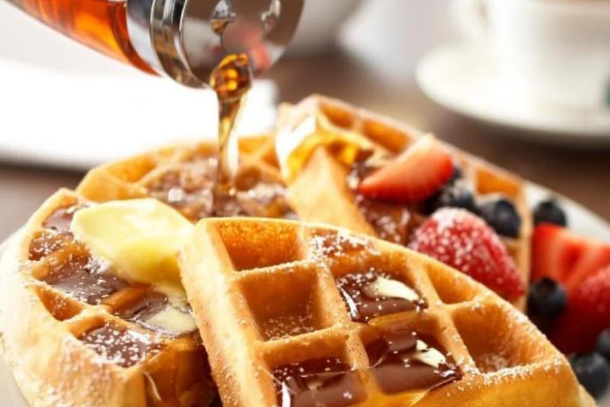 Syrup poured over waffles with berries and butter at Parkview Inn and Suites breakfast in Lancaster PA