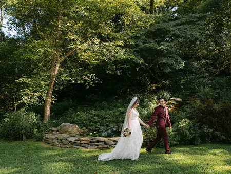 Bride and groom holding hands on wooded wedding venue at Pheasant Run Farm Bed and Breakfast in Lancaster PA