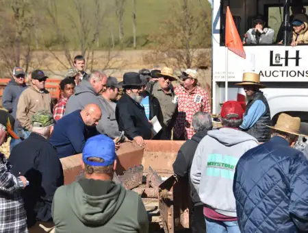 L&H Auctions crowd bidding on farm equipment at outdoor auction in Lancaster PA