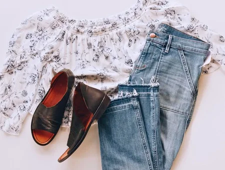 Purple Turtle Consignment Boutique flat lay of floral top, distressed jeans, and leather sandals, Lancaster PA resale fashion