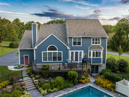 Aerial view of blue two story home with deck and pool for realtor listing in Lancaster County PA