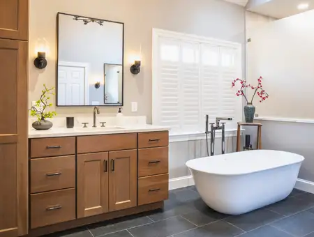 Bathroom remodel with freestanding tub and wood vanity in Lancaster PA