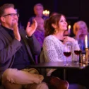 Guests enjoying wine and applauding the show at Magic and Wonder Dinner Theater on Route 30 in Lancaster PA