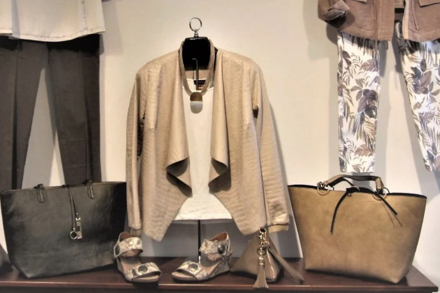 Ruthie's Apparel display of cardigan, tote bags, wedge sandals, and floral pants, Lancaster PA women's fashion