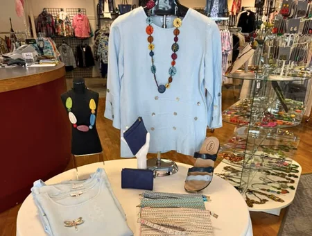 Ruthie's Apparel table display of blue top, necklace, sandals, and accessories, Lancaster PA women's boutique
