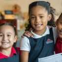 Three smiling students in uniform at Dayspring Christian Academy in Lancaster PA