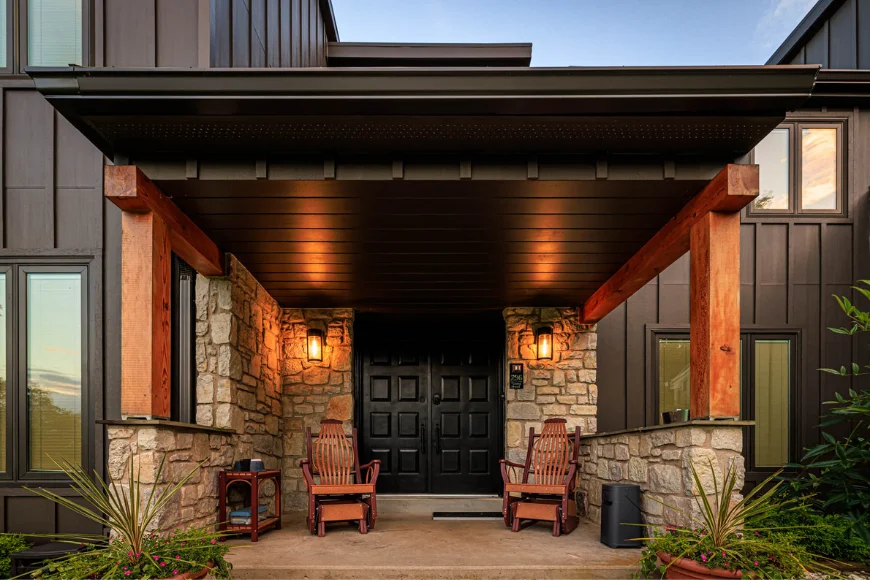 Stone entryway with black double front doors and covered porch by Smuckers Exterior and Remodeling in Lancaster County PA