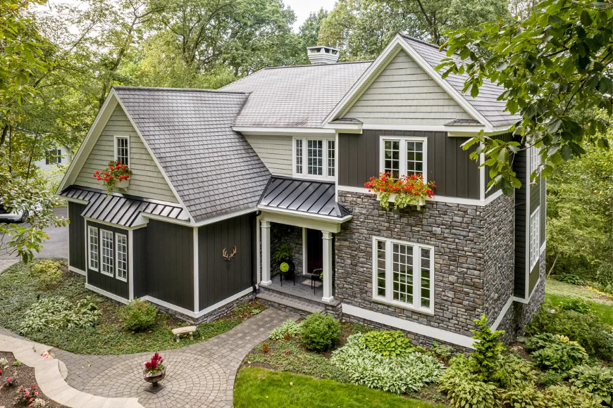 Two story home exterior with stone siding and board and batten remodel by Smuckers Exterior and Remodeling in Lancaster County PA