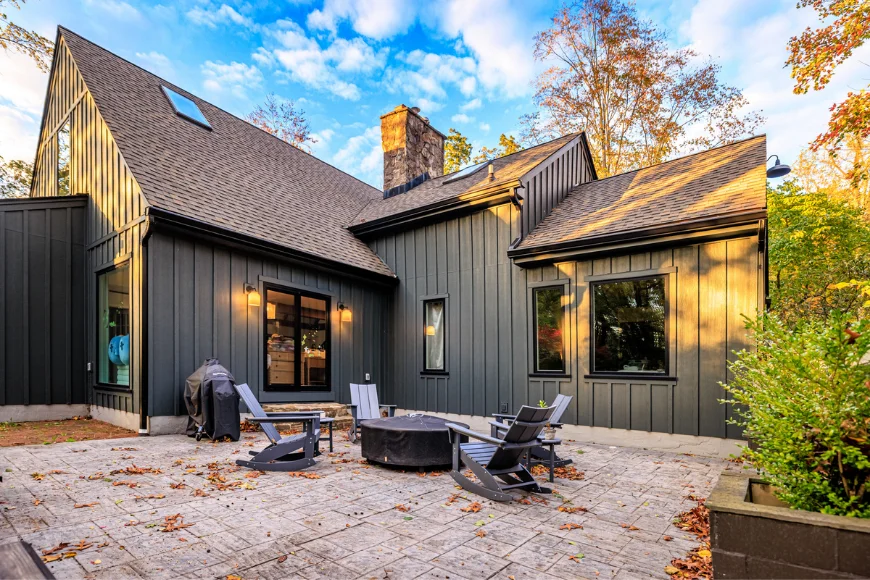 Home exterior with dark vertical siding and patio fire pit remodel by Smuckers Exterior and Remodeling in Lancaster County PA