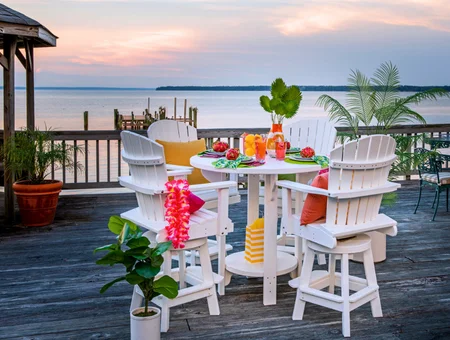 Snyder's Furniture white patio table and chairs on waterfront deck at sunset, Lancaster PA outdoor furniture