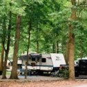Camper trailers under wooded canopy at Jellystone campground in Southern Lancaster County, Pennsylvania