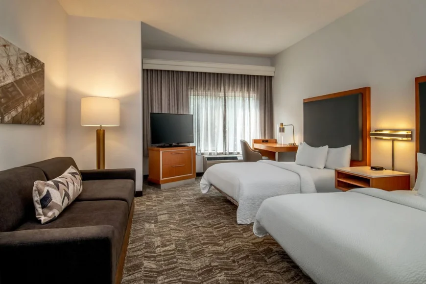 Double queen guest room at Springhill Suites Hershey, with a lounge sofa, work desk, and TV, near Hersheypark