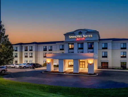 Springhill Suites Marriott exterior at dusk in Hershey, PA, with an illuminated entrance canopy and parking lot in front
