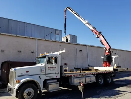 Boom truck with crane arm extended at Stoner Industrial Services yard in Lancaster PA
