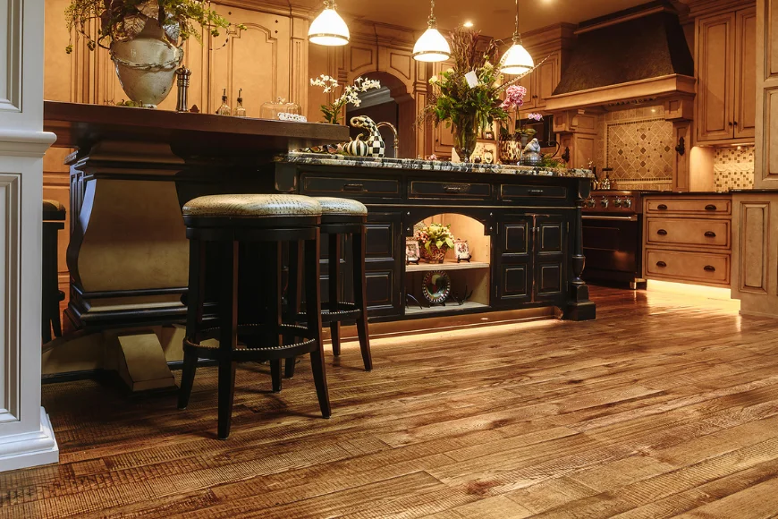 Sylvan Brandt reclaimed wood floor in kitchen with dark wood island and bar stools