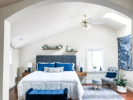 The Cottage and Loft bedroom image: vaulted bedroom with navy velvet accents, a queen bed, and a skylight in Lancaster, PA