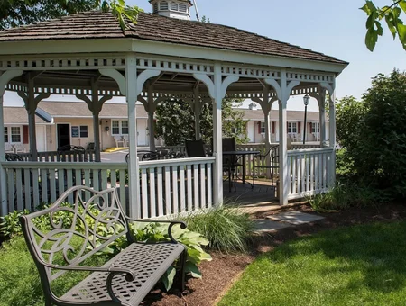 White gazebo with bench overlooking motel rooms at Travelers Rest Motel in Lancaster PA
