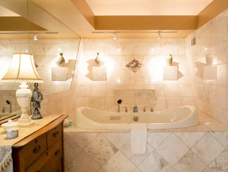 Twin Pine Manor bathroom image: marble bathroom with a soaking tub, decorative lighting niches, and vanity in Lancaster, PA