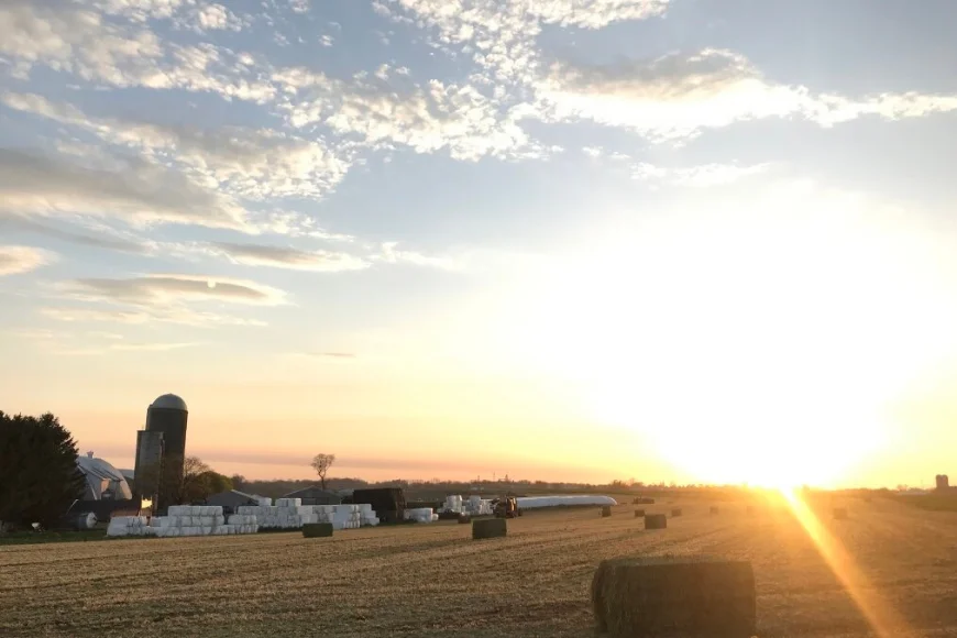 Sunset over farm field with hay bales near the Village of Intercourse PA