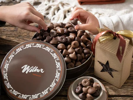 Wilbur Chocolate tin and gift box of milk chocolate kisses on wood table, Pennsylvania chocolate