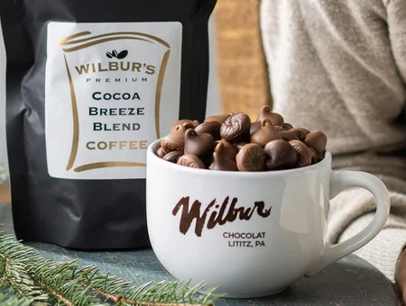Wilbur Chocolate mug filled with chocolate pieces beside coffee bag, Lititz PA chocolate