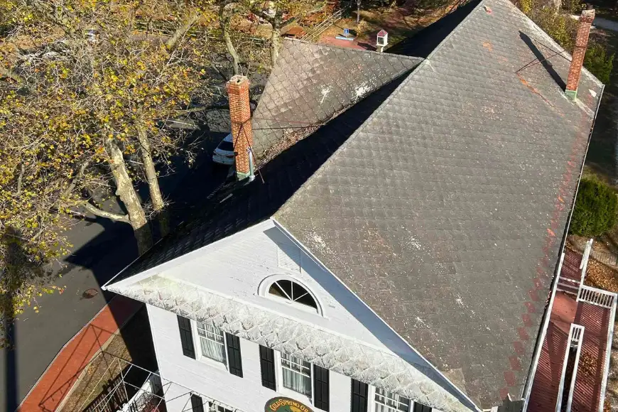 Aerial view of historic slate roof with brick chimneys by Detwiler Roofing Lancaster PA