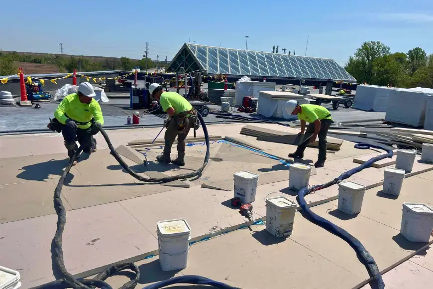 Roofing crew applying commercial flat roof replacement by Detwiler Roofing Lancaster PA