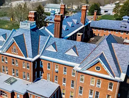 Aerial view of blue slate roof on historic brick building by Detwiler Roofing Lancaster PA