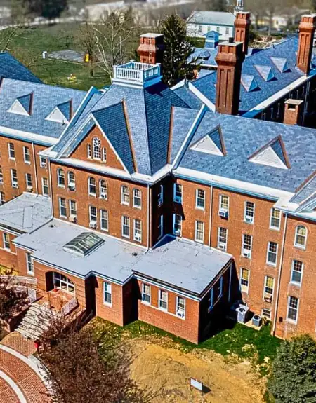 Aerial view of blue slate roof on historic brick building by Detwiler Roofing Lancaster PA