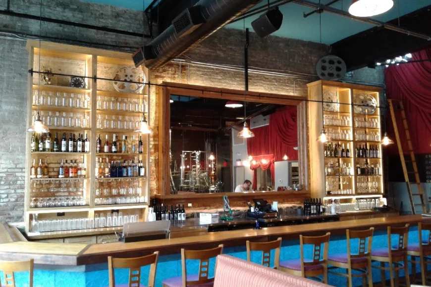 Bar and lounge with backlit shelving and stage curtain at a Lancaster PA venue