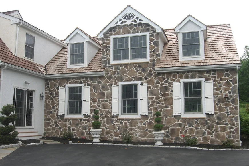 Stone home with cedar shake roof and dormers built by Forest Ridge Builders Lancaster PA