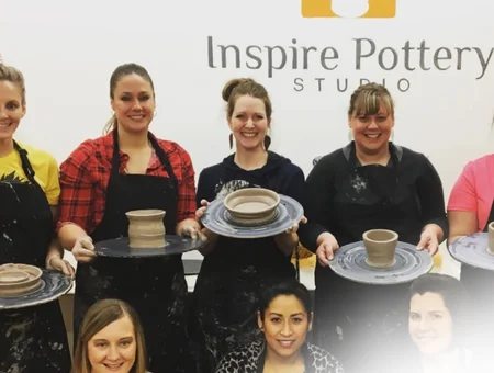 Group holding finished pottery pieces at Inspire Pottery Studio in Lancaster, Pennsylvania