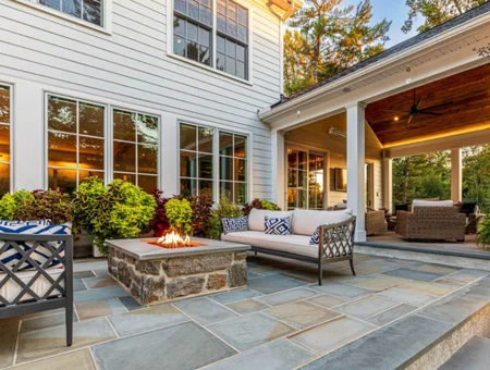 Stone fire pit and covered porch seating by Kauffman Exteriors Lancaster PA