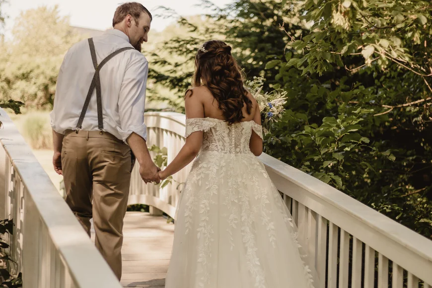 Bride and groom crossing garden bridge at Pheasant Run Farm Bed and Breakfast in Lancaster, Pennsylvania