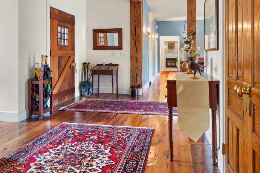 Farmhouse entry hallway with exposed beams at Pheasant Run Farm Bed and Breakfast in Lancaster, Pennsylvania